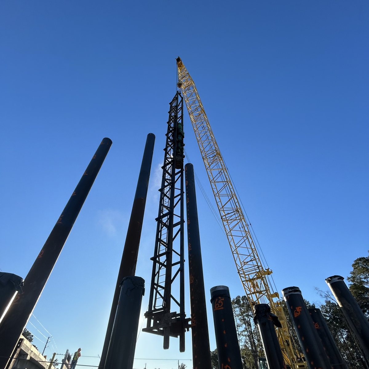 Steel pile driving operation under a clear sky